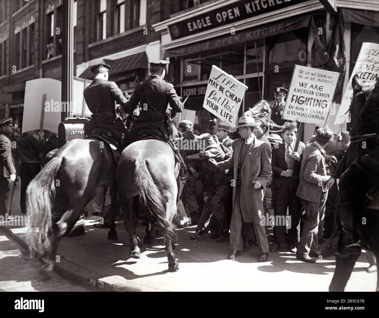 New York, New York:   1936 Mounted police charge the strikers on the waterfront as they rushed Pier 61 when the S.S. Virginia prepared to sail for California. Stock Photo
