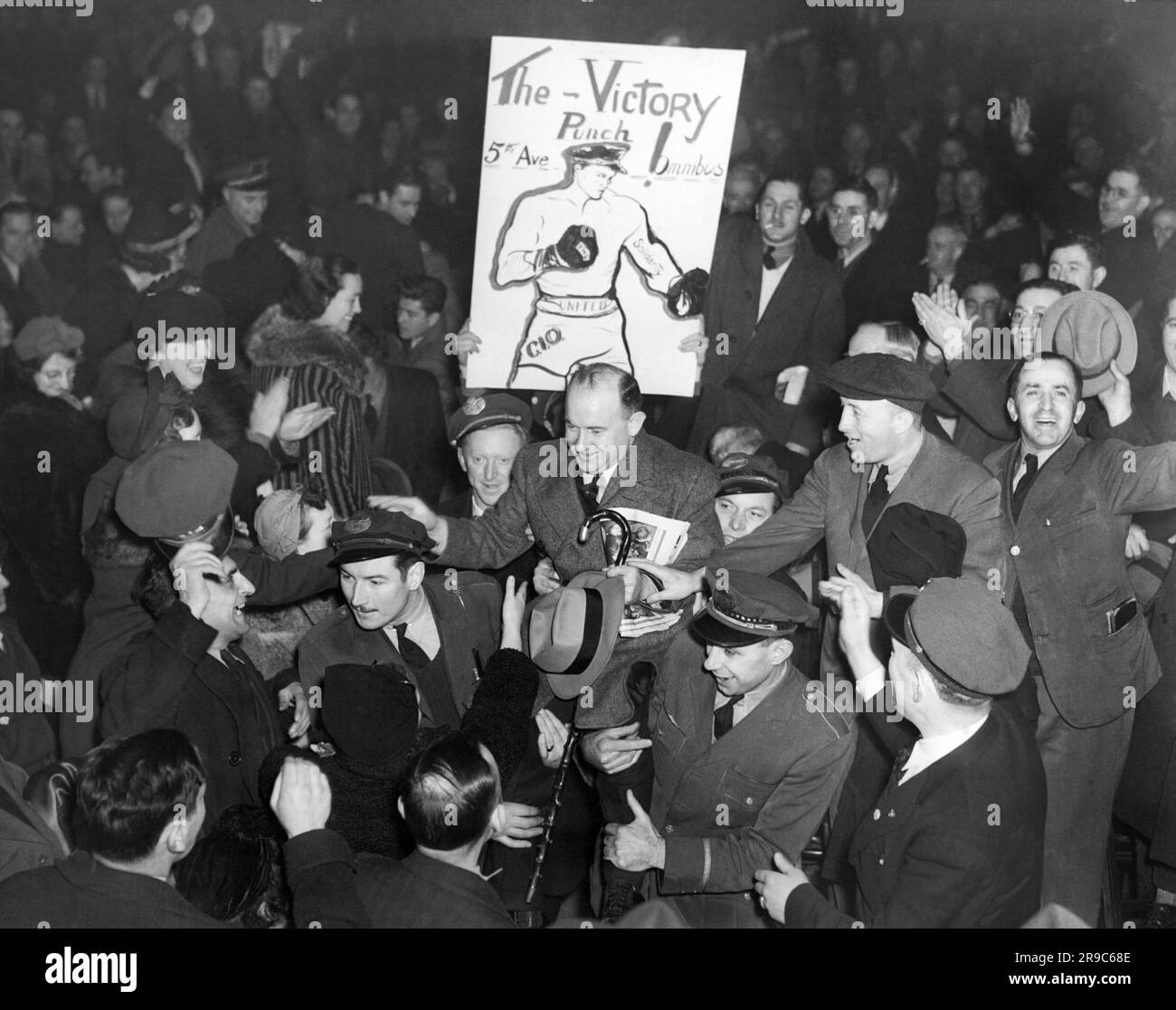 New York, New York:   1937 Members of the Transit Workers Union carry their international president, Michael J. Quill, up to the speakers' platform during a bus strike union meeting. Stock Photo