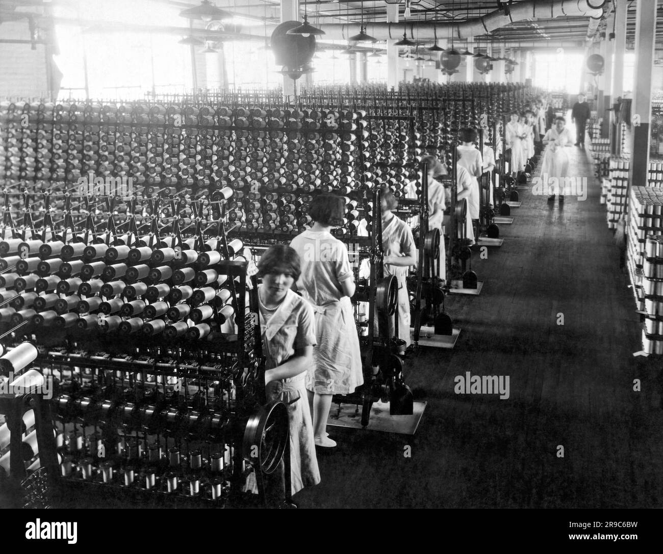 Connecticut:  c. 1921 Women working at silk winding machines that will be used in the manufactring of ladies hosiery. Stock Photo