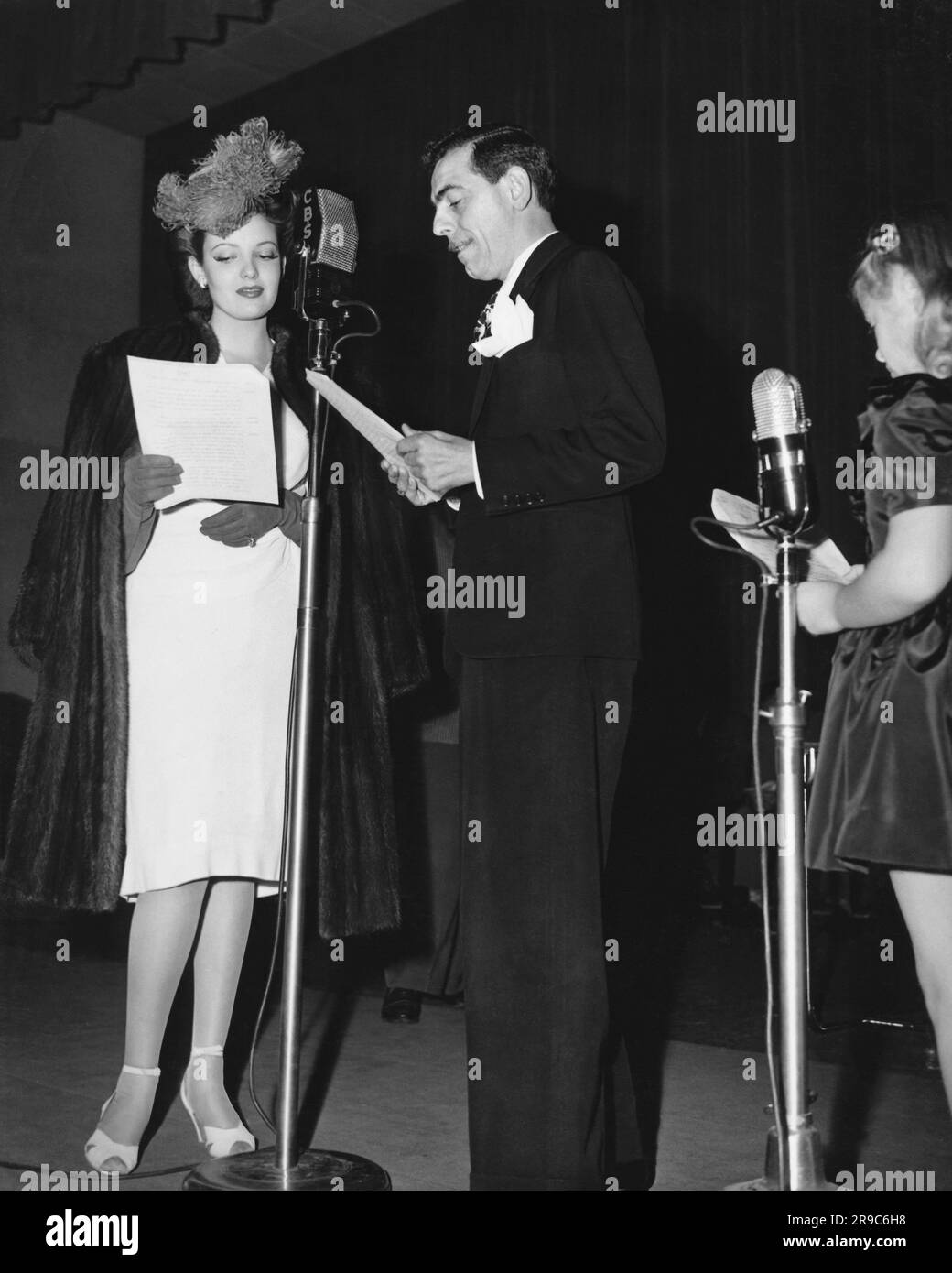 United States: c. 1939 Radio performers broadcasting a live radio show