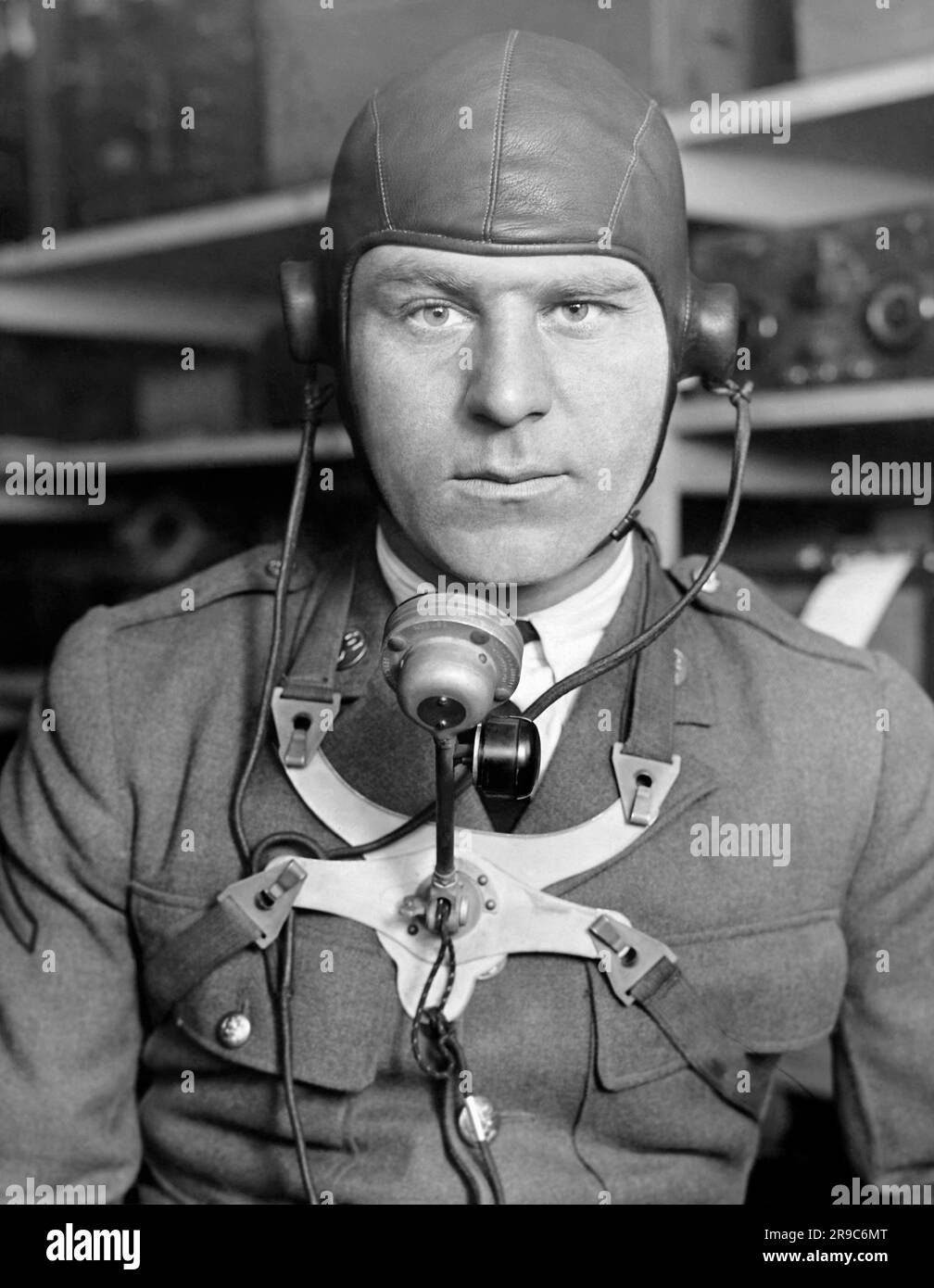 United States:   c. 1927 A member of the Army Signal Corps demonstrates the newly developed helmet and transmitter for use in aircraft. Stock Photo