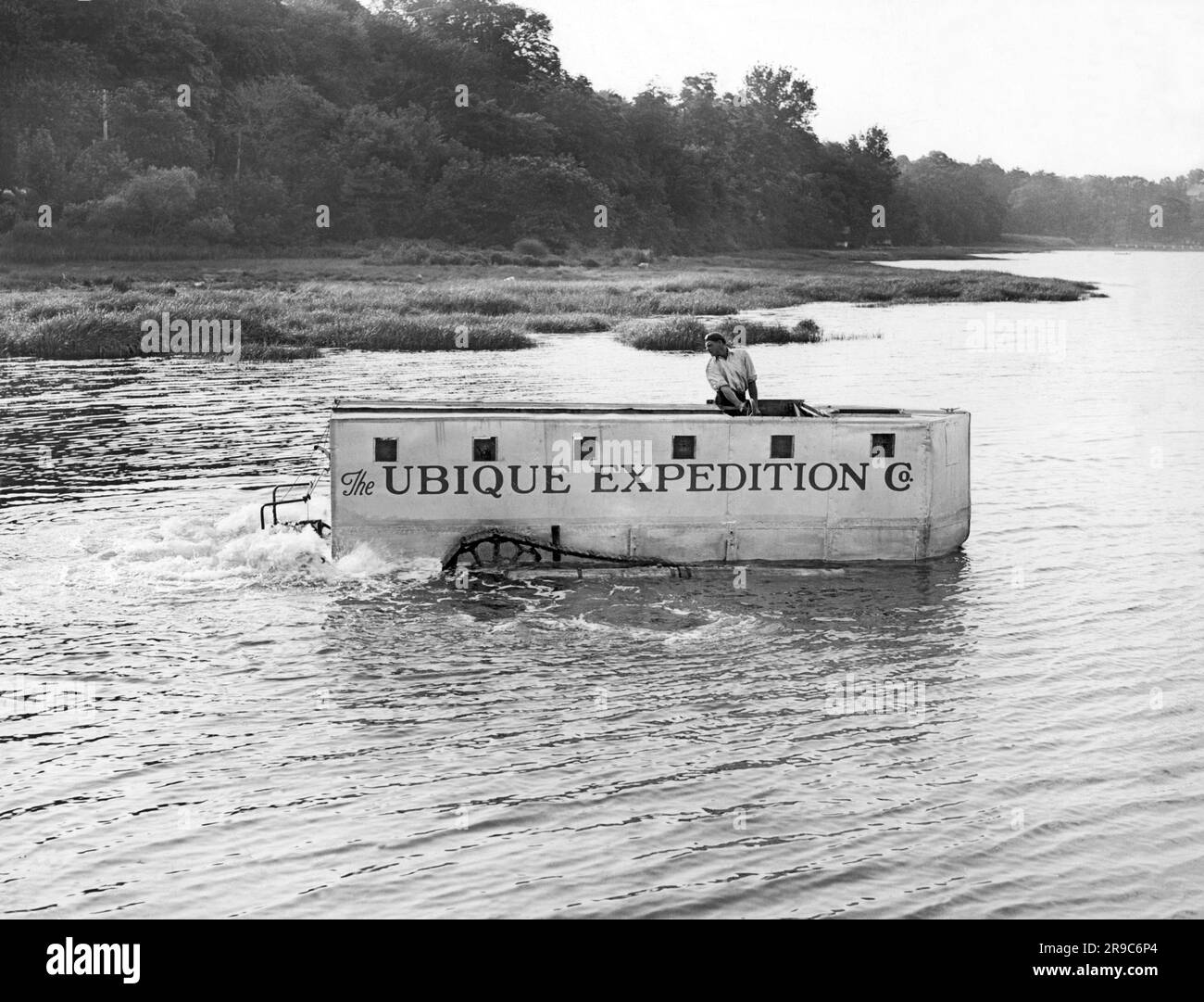 Kings Point, New York:  c. 1933 Explorer John H. Ubique tests out his amphibian vehicle with which he hopes to lead an expedition into the jungles of South America in a search tp find the lost avaitor, Paul Redfern. It has tractor treads and paddles to propel it. Stock Photo