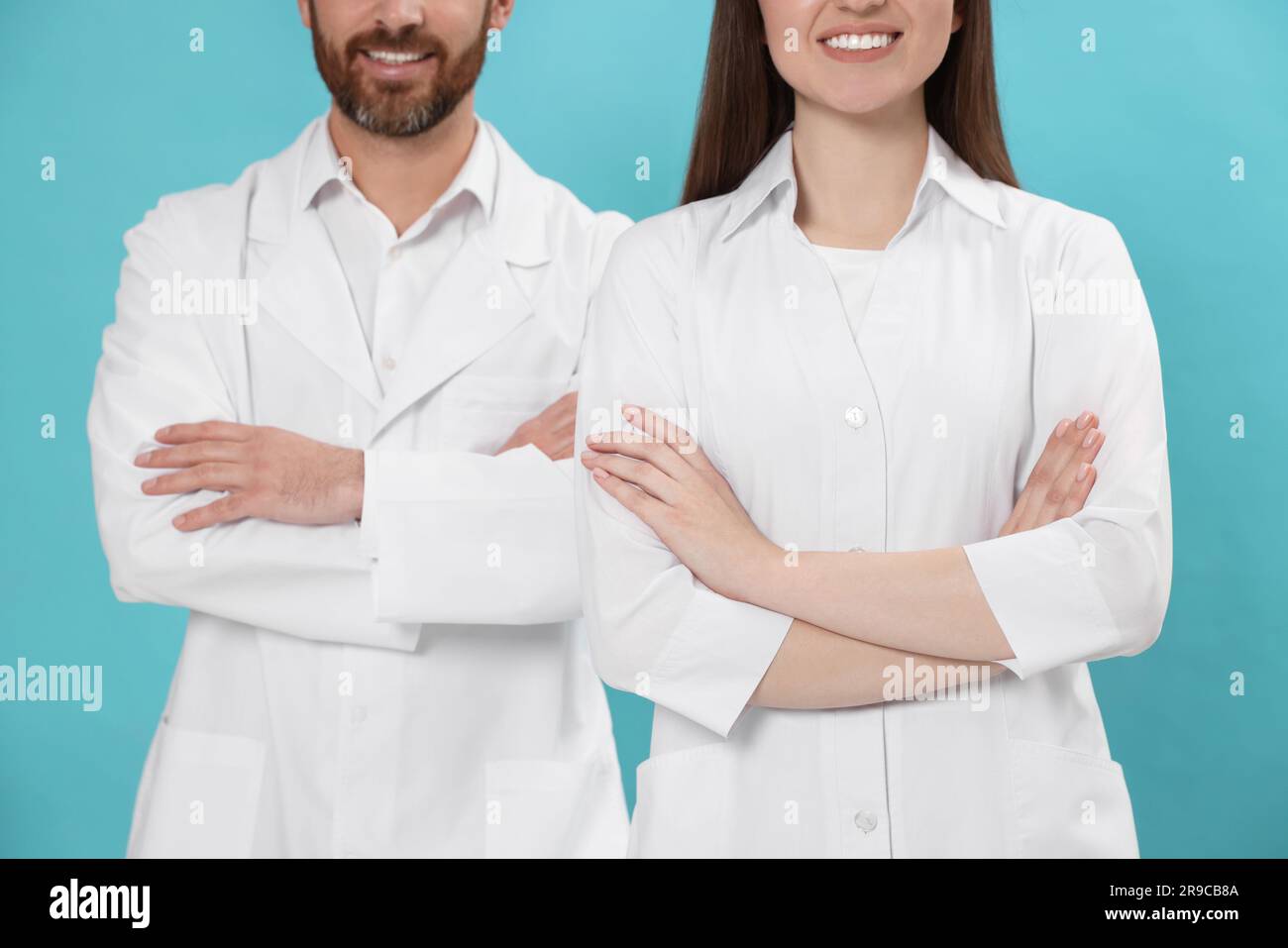 Nurses in medical uniform on light blue background, closeup Stock Photo ...