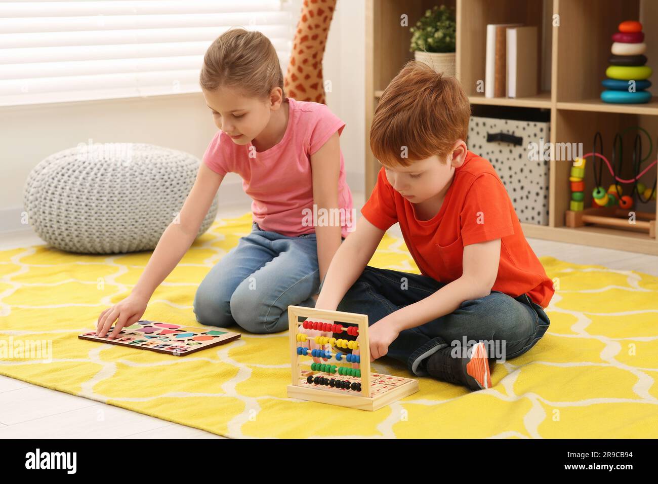 Children playing with math game kits on floor in room. Learning
