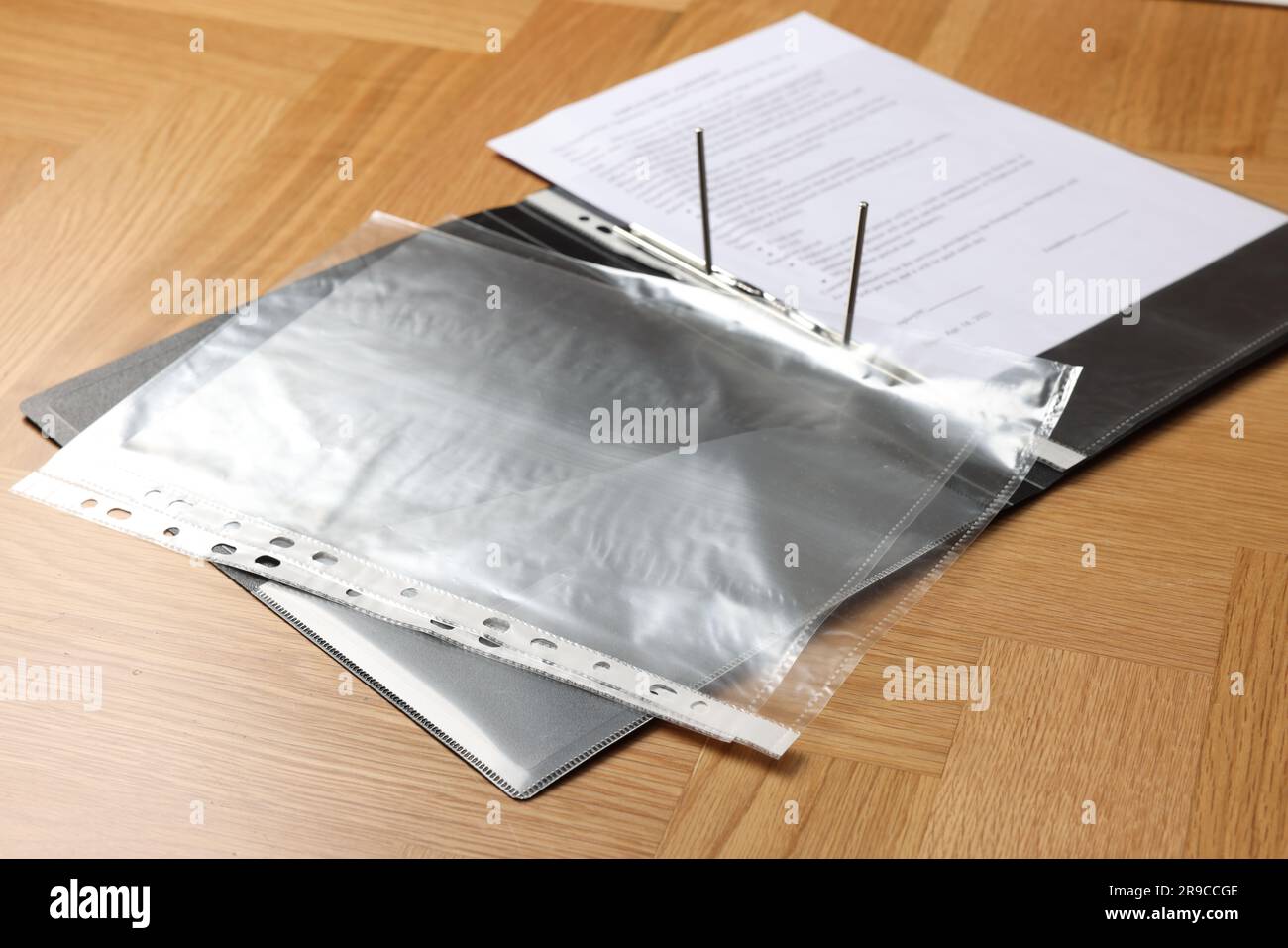 File folder with punched pockets on wooden table Stock Photo