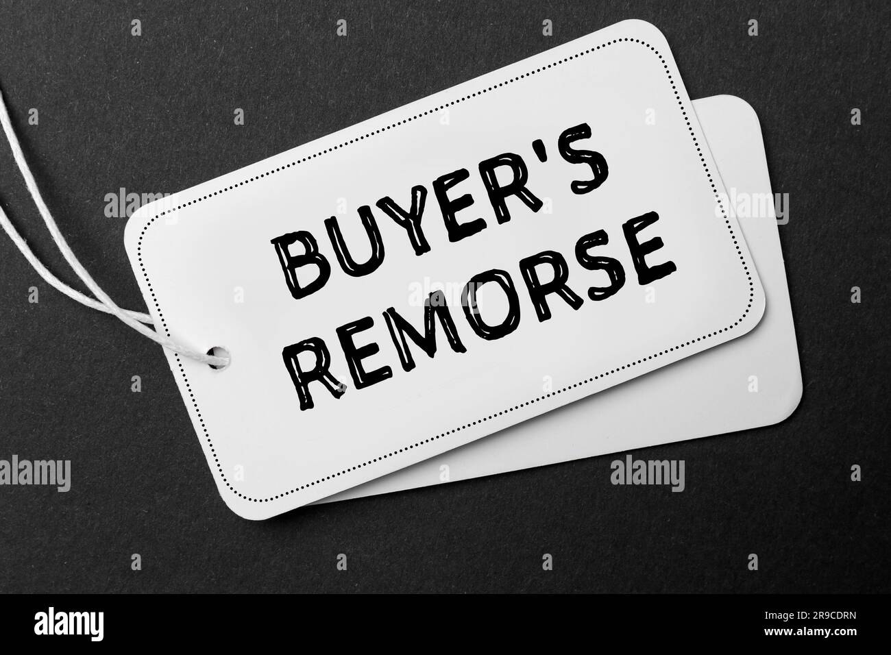 Tag with text Buyer's Remorse on black background, top view Stock Photo