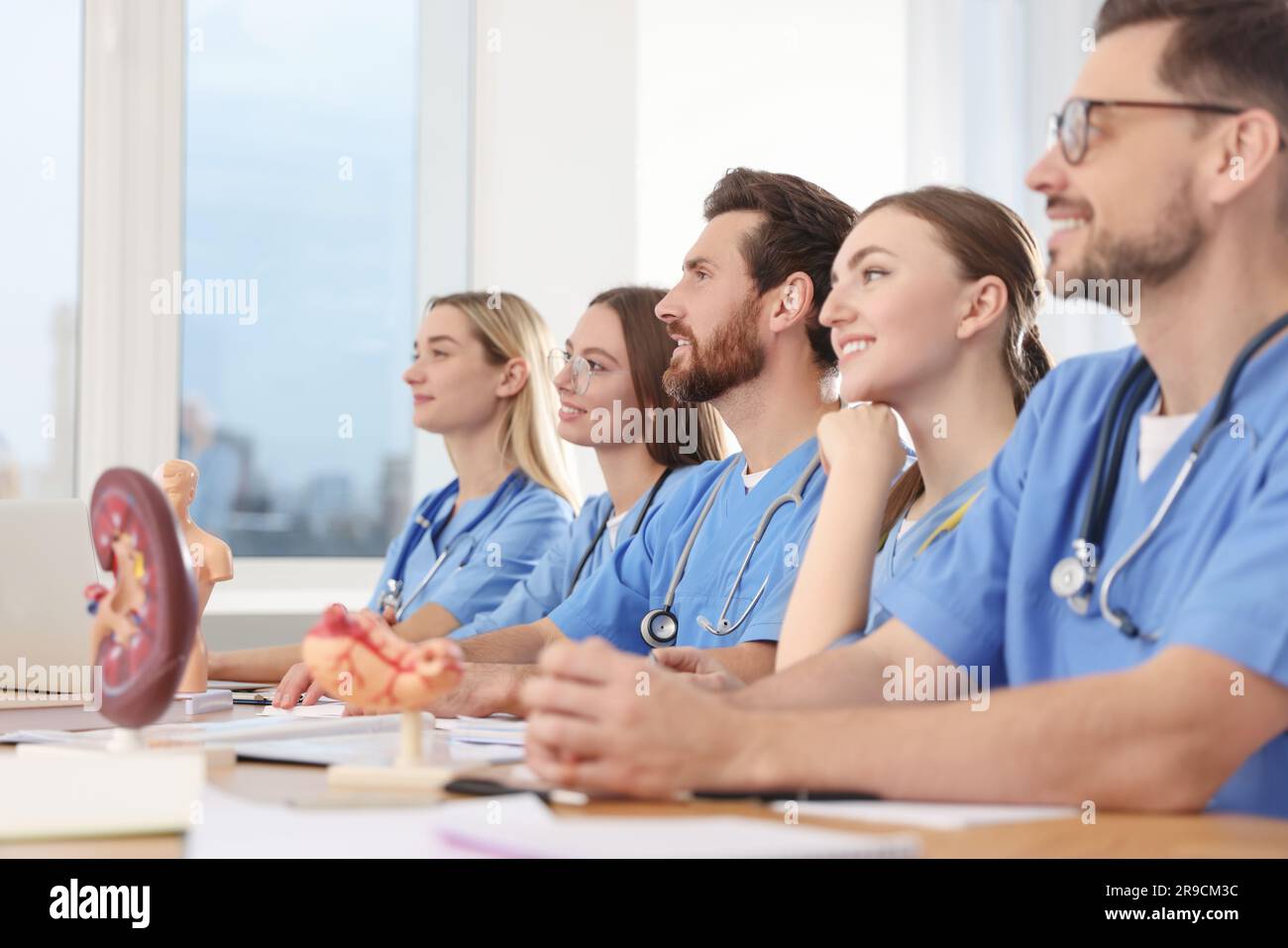 Medical students in uniforms studying at university Stock Photo
