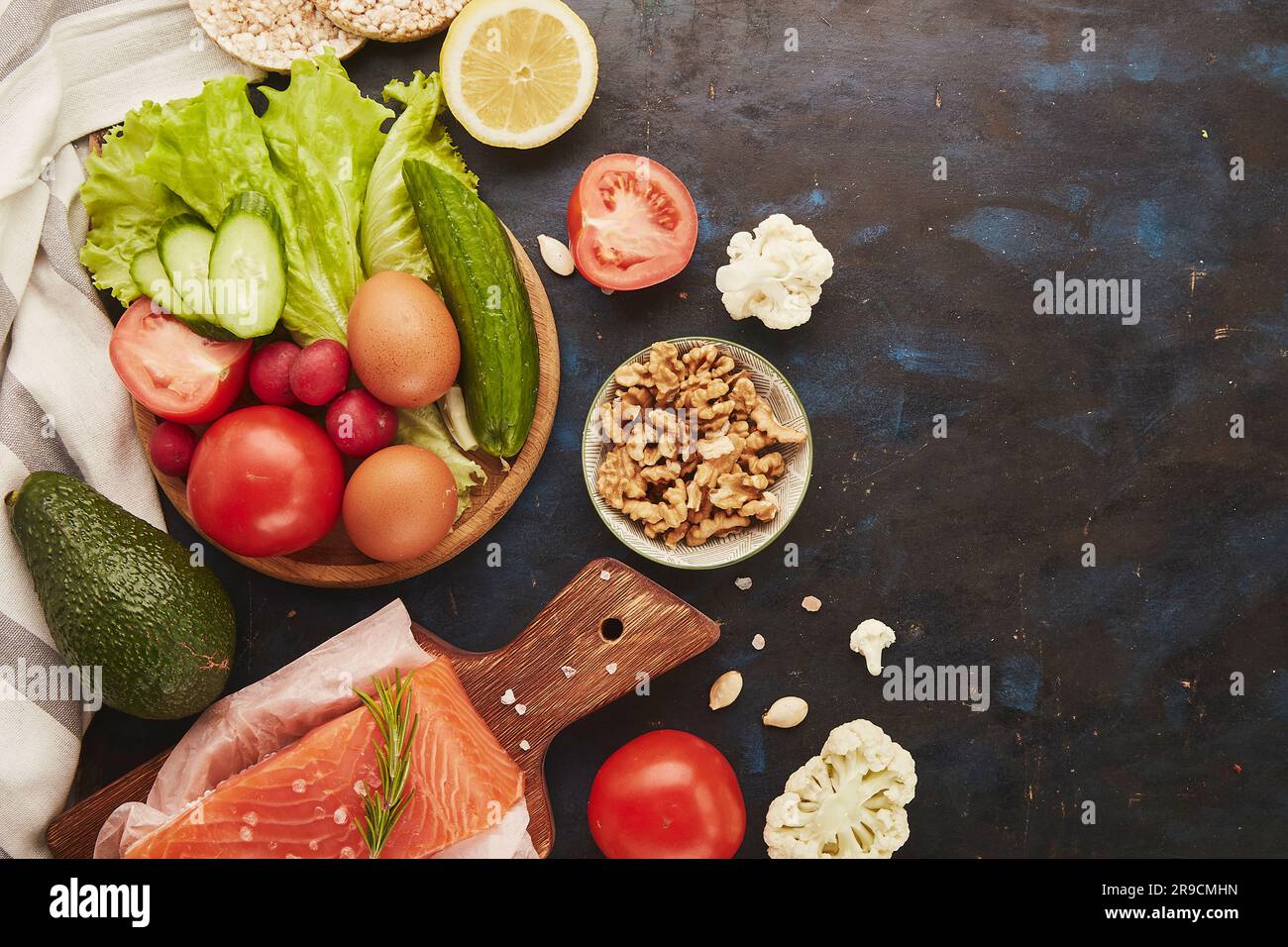 Fodmap Mediterranean diet with copy space. Healthy low fodmap ingredients - vegetables, fruits, nuts, greens, avocado. Flat lay Stock Photo