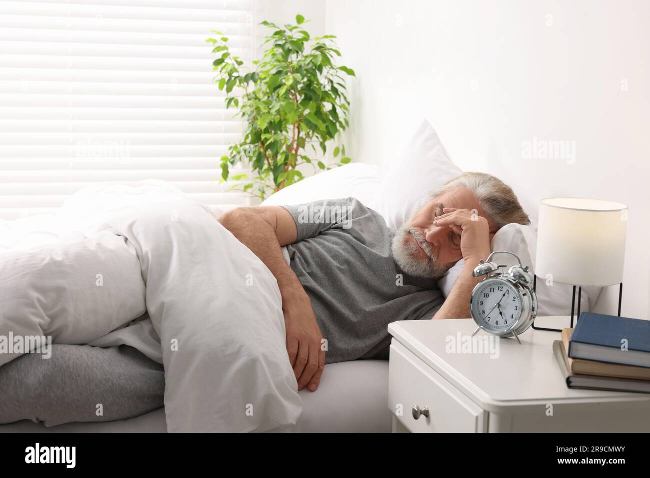 Senior man sleeping in bed at home Stock Photo - Alamy