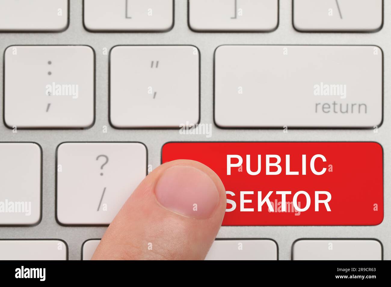 Man pressing red button with text Public Sector on computer keyboard, closeup Stock Photo