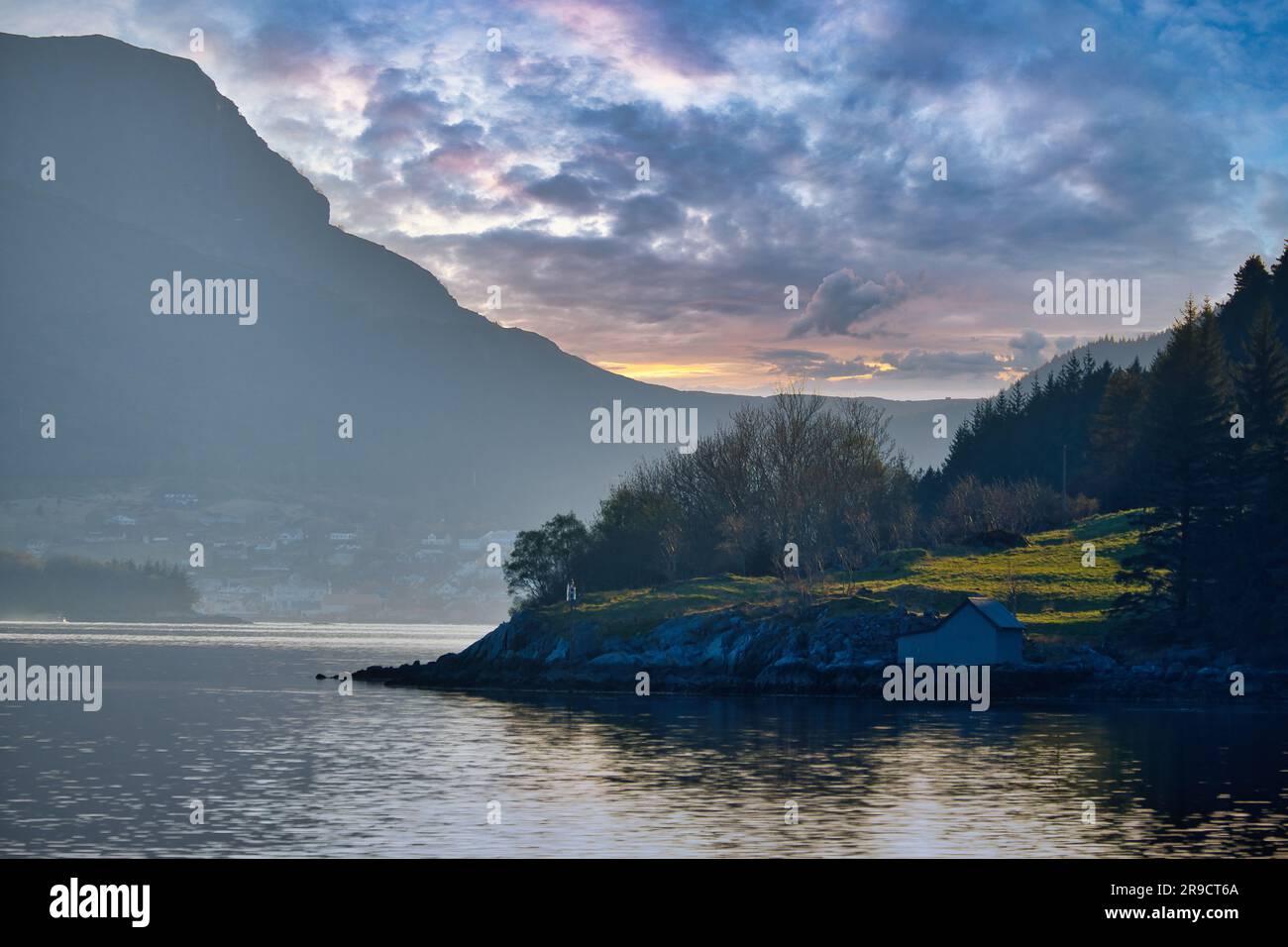 Diffuse Landscape Sunset on the fjord with mountains in Norway. Diffuse light, sun rays ...