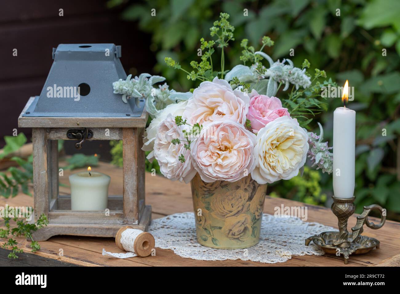 romantic arrangement with bouquet of english roses and candles Stock Photo