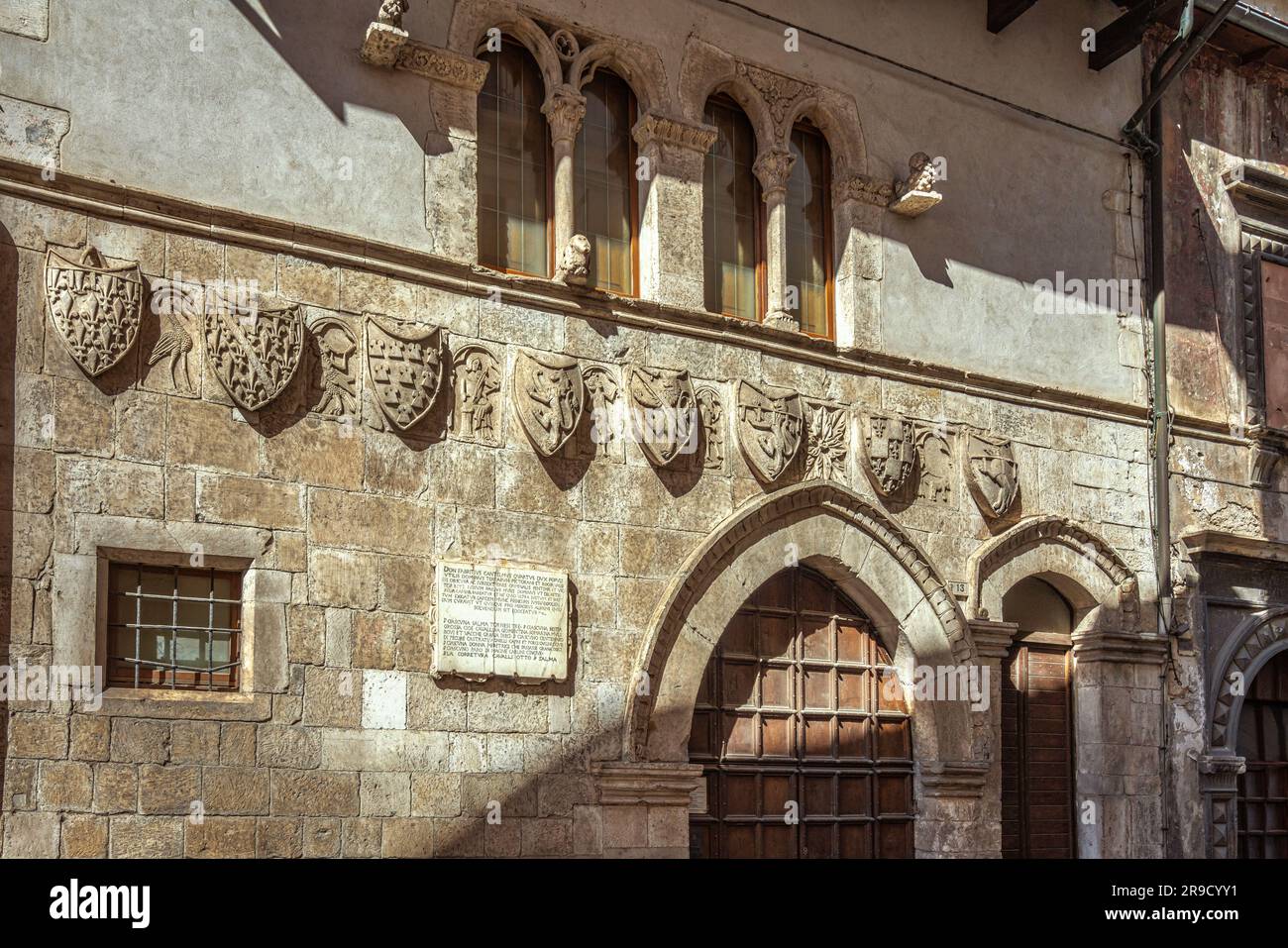 The facade of the Ducal Tavern of Popoli with the heraldic coats of arms of the families related to the Cantelmo and D'Angiò. Popoli, Abruzzo Stock Photo