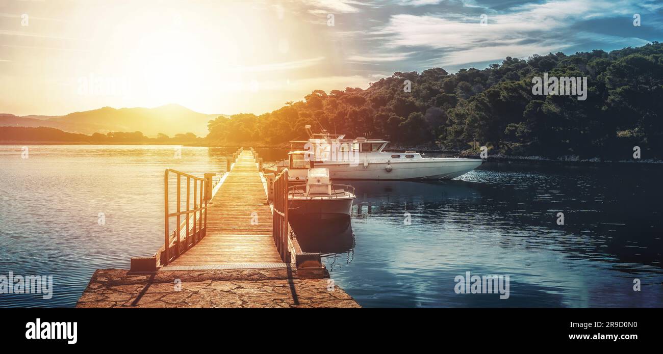 yacht moored in harbor, with pier in foreground Stock Photo - Alamy