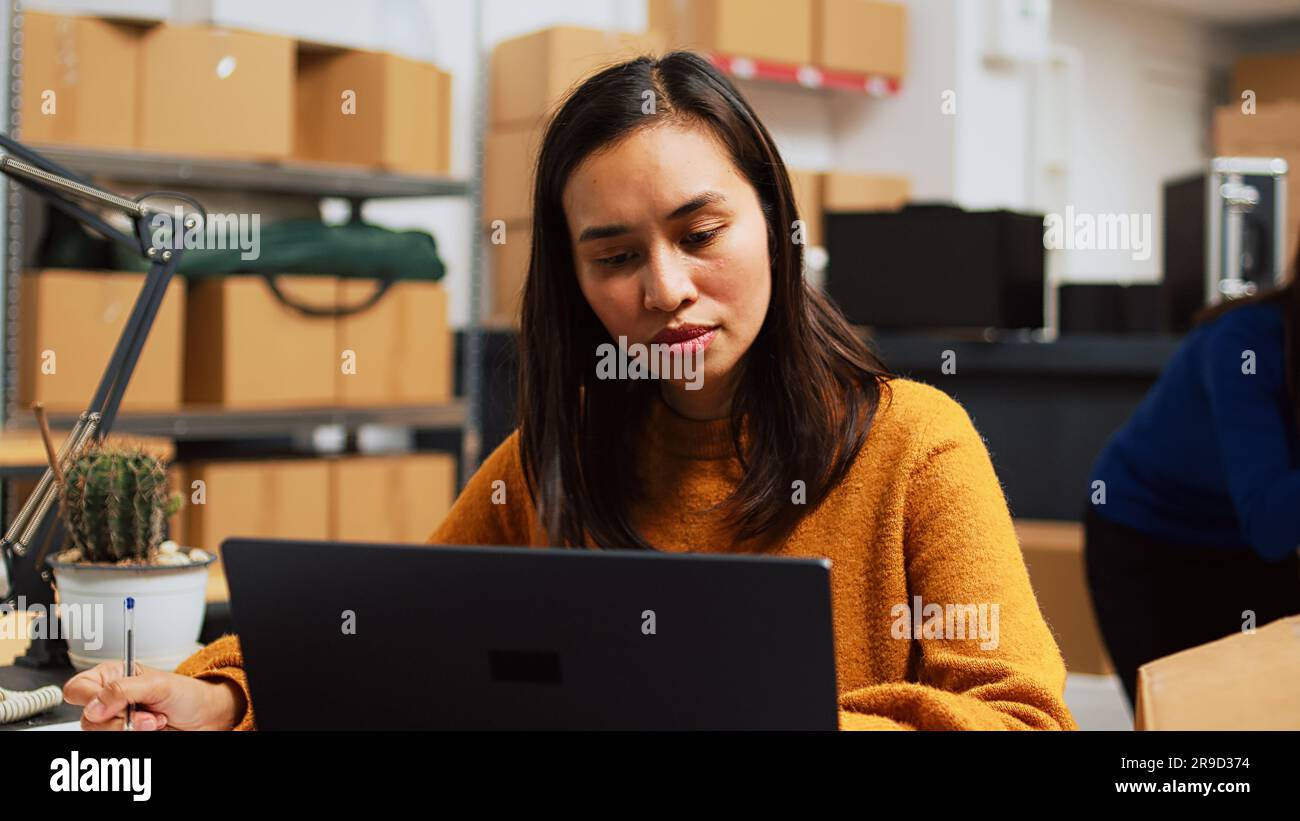 Sparknotes Owner Young startup owner working on laptop to plan logistics, preparing ...