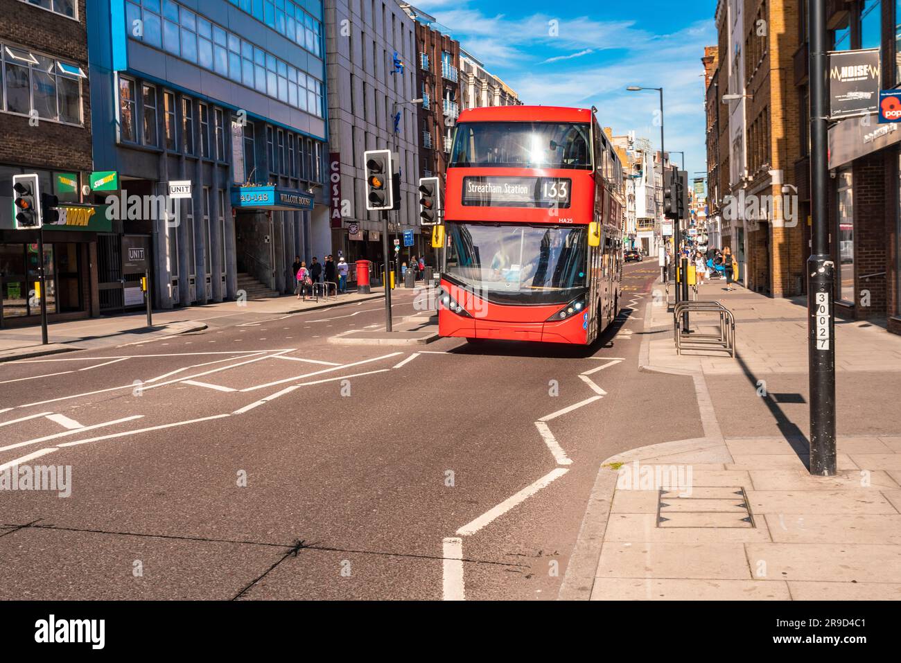 Borough High Street with red bus and blue sky Stock Photo - Alamy