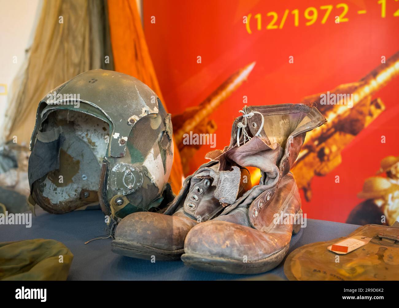 A battered flying helmet and leather boots from a US Airman who was shot down during the 'Christmas Bombing' of Hanoi in the Vietnam War in 1972, on d Stock Photo