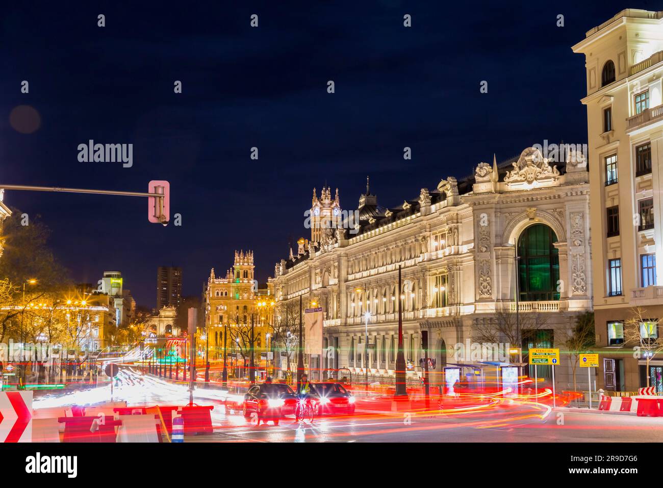 Madrid, Spain - FEB 17, 2022: Night view in long exposure on the Calle de Alcala, Madrid. Historical buildings, palaces, hotels and the cars in motion Stock Photo