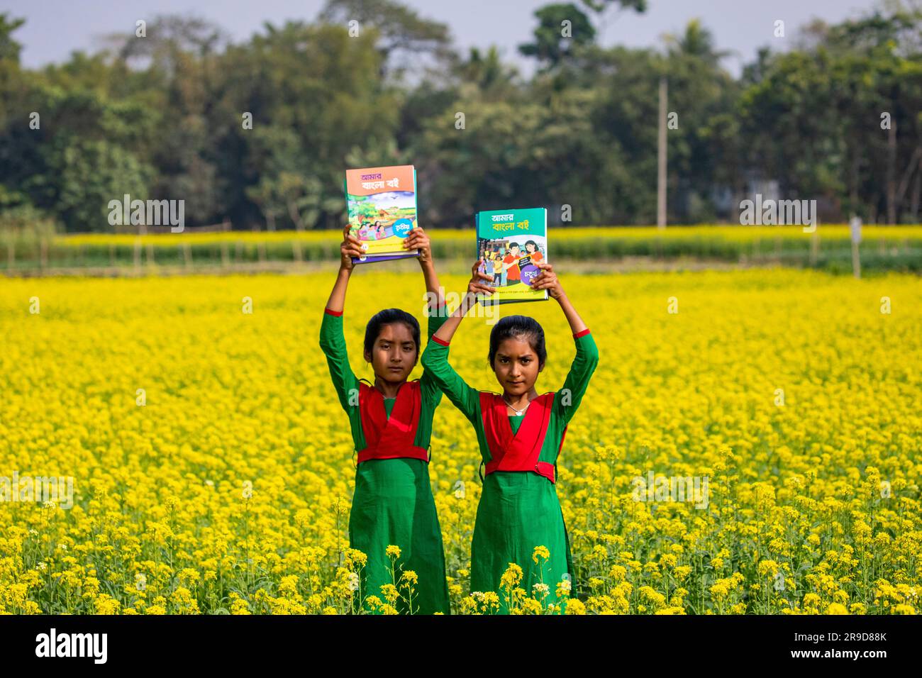 Bangladeshi primary school students celebrate as they get their new textbooks for new classes at Singair in Manikganj. Bangladesh. The government dist Stock Photo