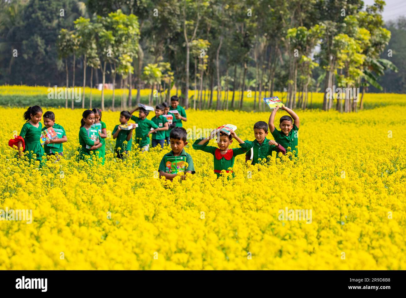 Bangladeshi primary school students celebrate as they get their new textbooks for new classes at Singair in Manikganj. Bangladesh. The government dist Stock Photo