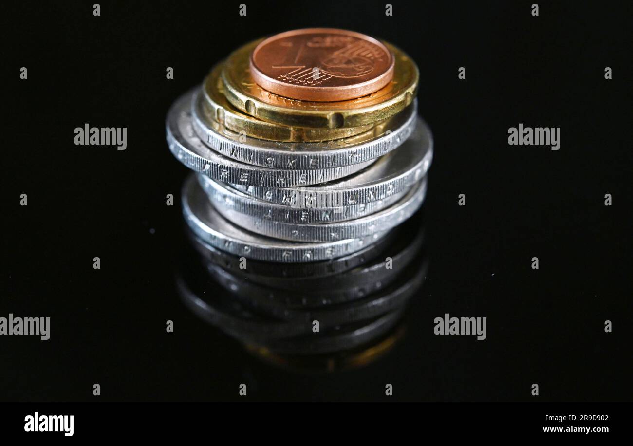 Stuttgart, Germany. 26th June, 2023. ILLUSTRATION - Coins worth 12.41 euros  lie on a black surface (posed scene). The general statutory minimum wage in  Germany is to rise from 12.00 to 12.41