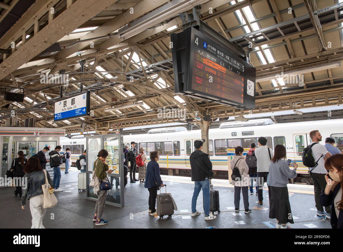 Kyoto railway station 2023, passengers on a platform wait for their