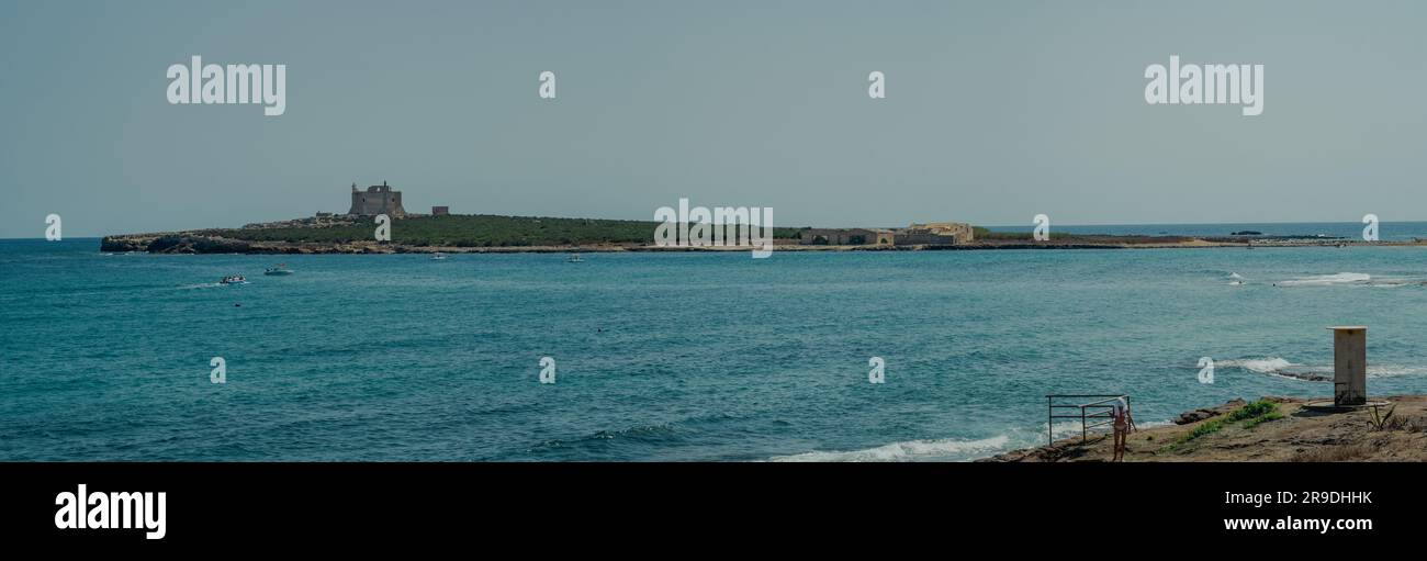 The flat island of Capopassero seen from Portopalo, Syracuse, Sicily, Italy Stock Photo