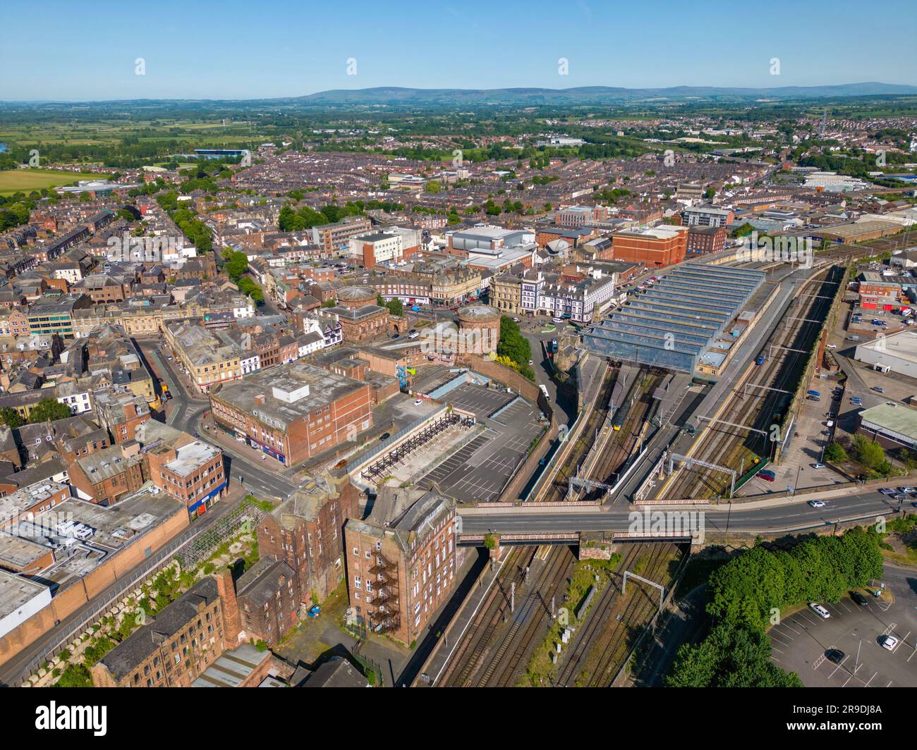An aerial drone photo of the town center of Carlisle and the large train station with railways. Stock Photo