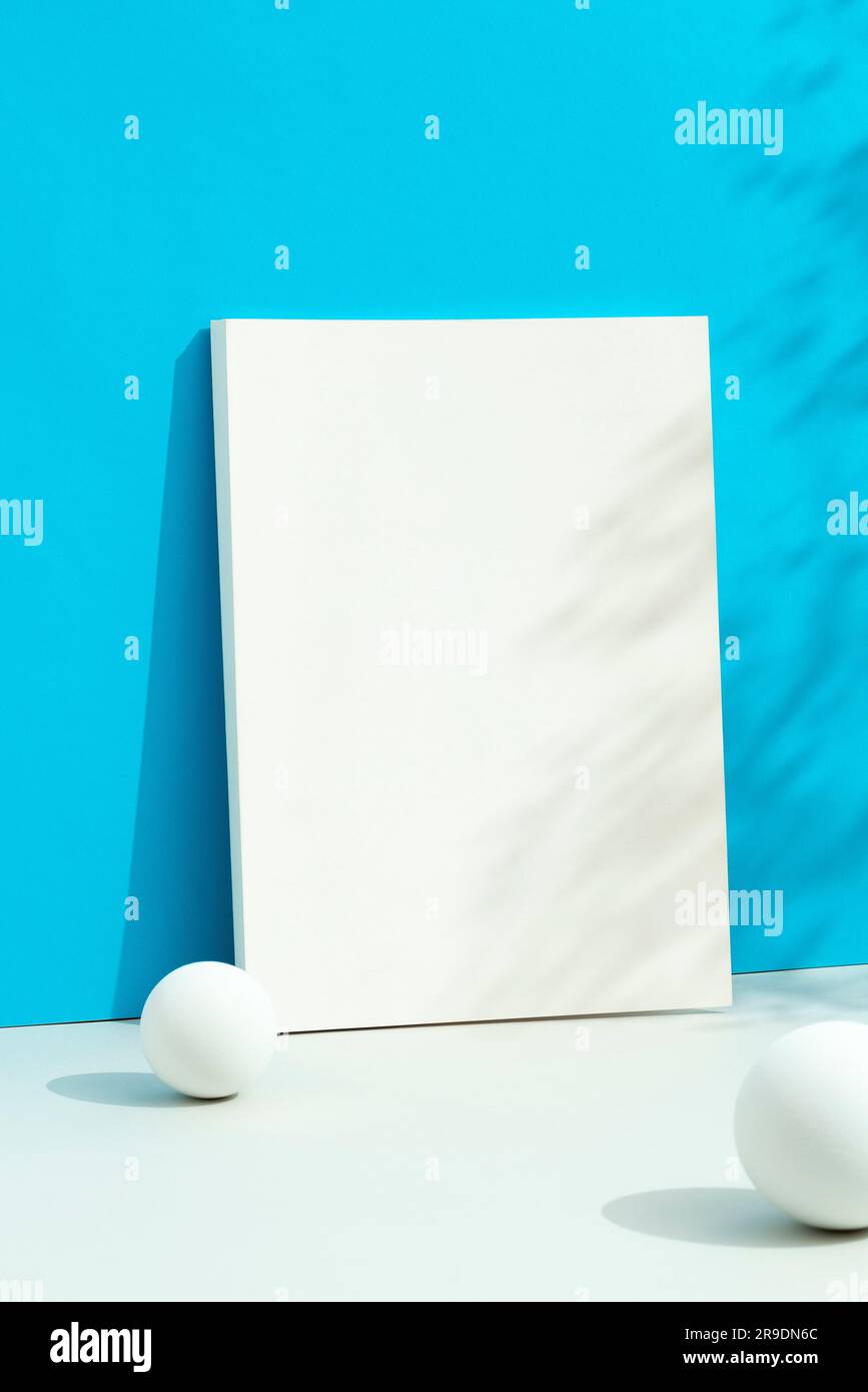White blank magazine cover mockup on blue background with floral