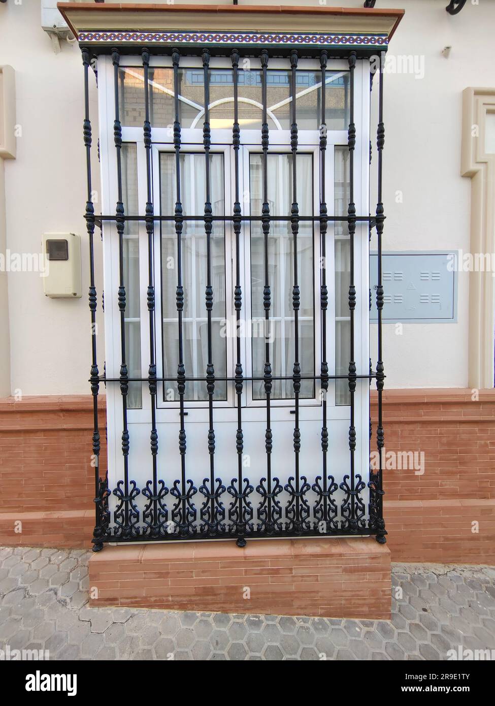 Windows with black bars on a wall In Andalusia Stock Photo Alamy