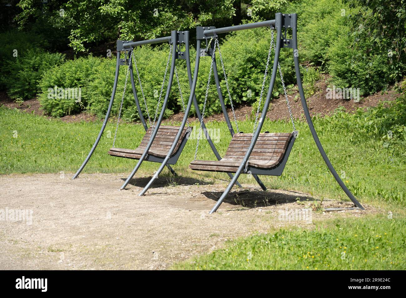 Two lonely swings await their users Stock Photo