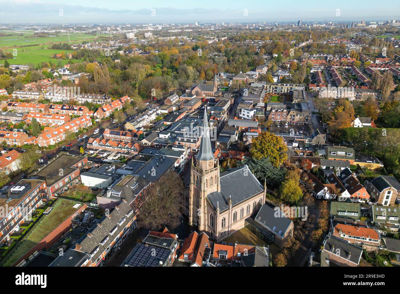 Aerial drone photo of the town centre of Voorschoten in the Netherlands. There is a shopping street and a church. Stock Photo