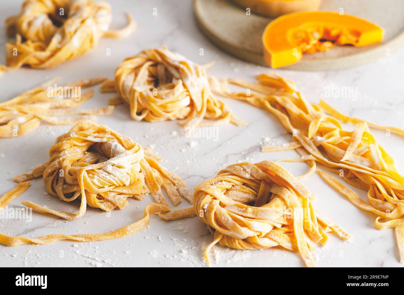 Butternut squash noodle nests and some slices of butternut squash in a