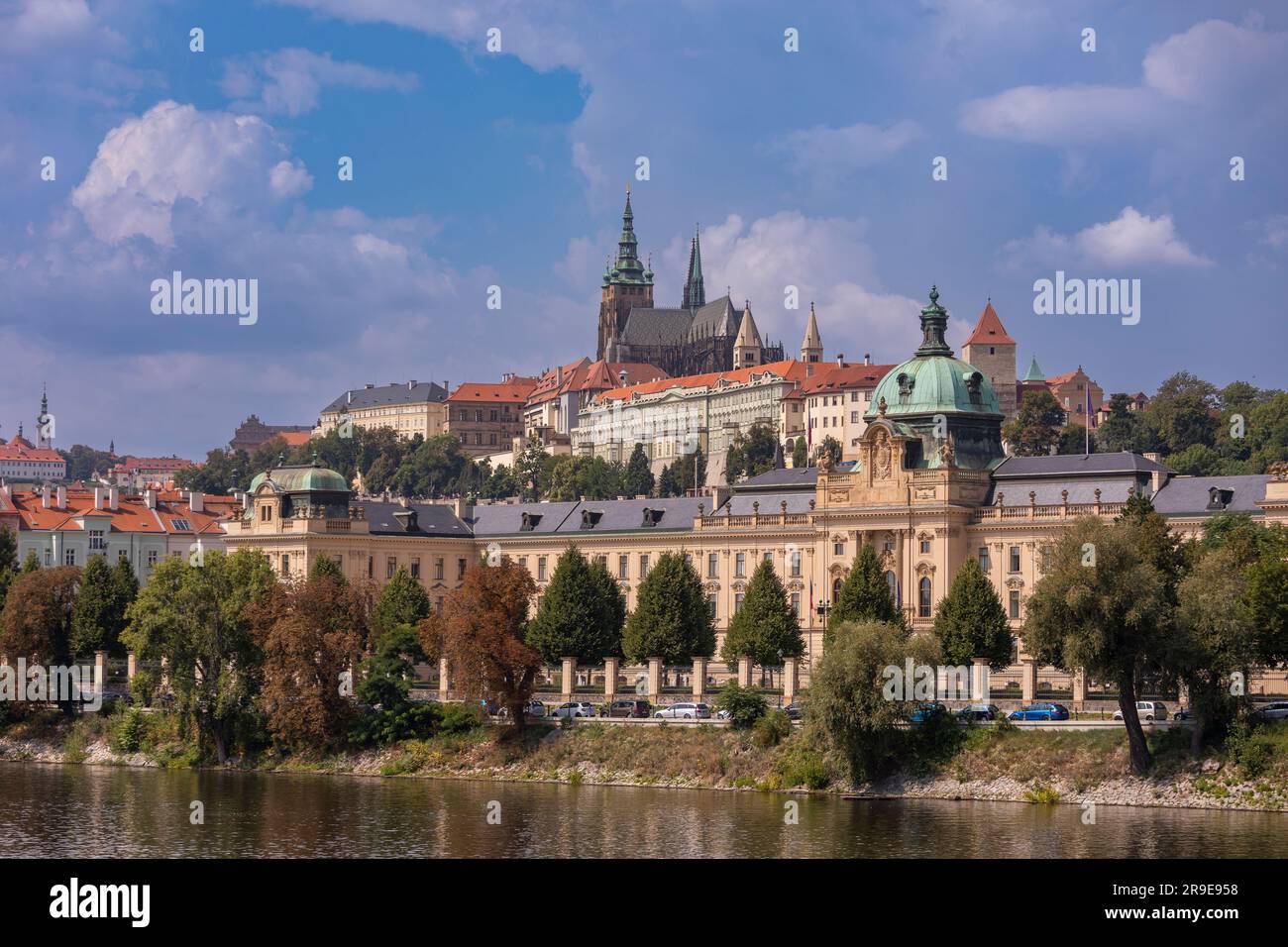 PRAGUE, CZECH REPUBLIC, EUROPE - Straka Academy building, the office of the Czech Republic Government, on the Vltava RIver. Above left is Prague Castl Stock Photo