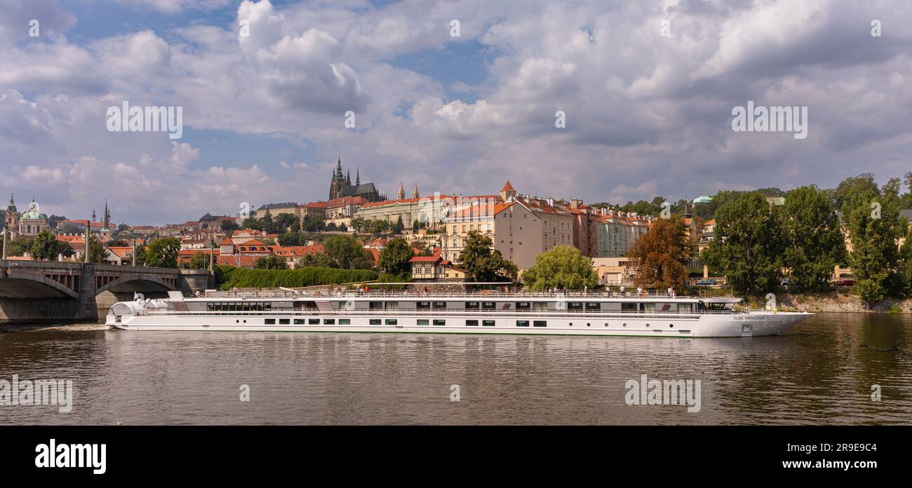 PRAGUE, CZECH REPUBLIC, EUROPE - Boat cruise with tourists on Vltava RIver, passes Prague Castle district. Panorama Stock Photo