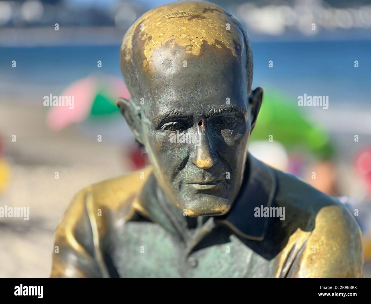 A statue of renowned Brazilian poet Carlos Drummond de Andrade near a picturesque beach in Brazil Stock Photo