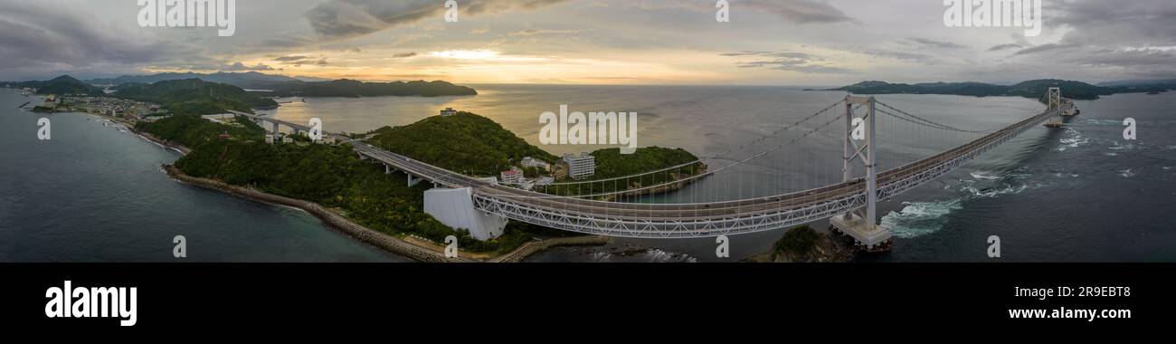 Panoramic aerial view of suspension bridge on coast at sunset Stock Photo