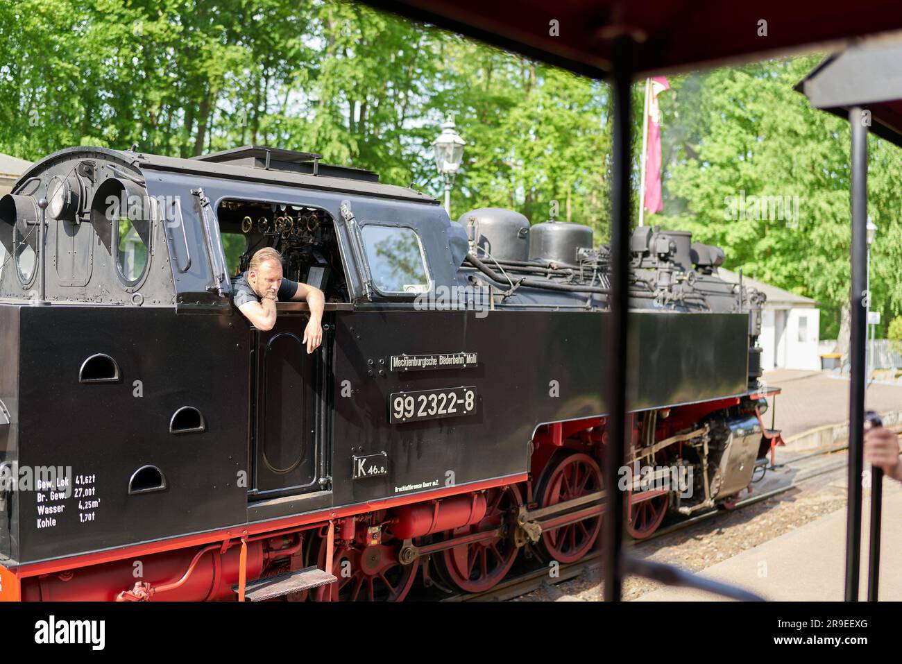 Stoker of the steam locomotive tourist train Molli in Heiligendamm station talking to tourists Stock Photo