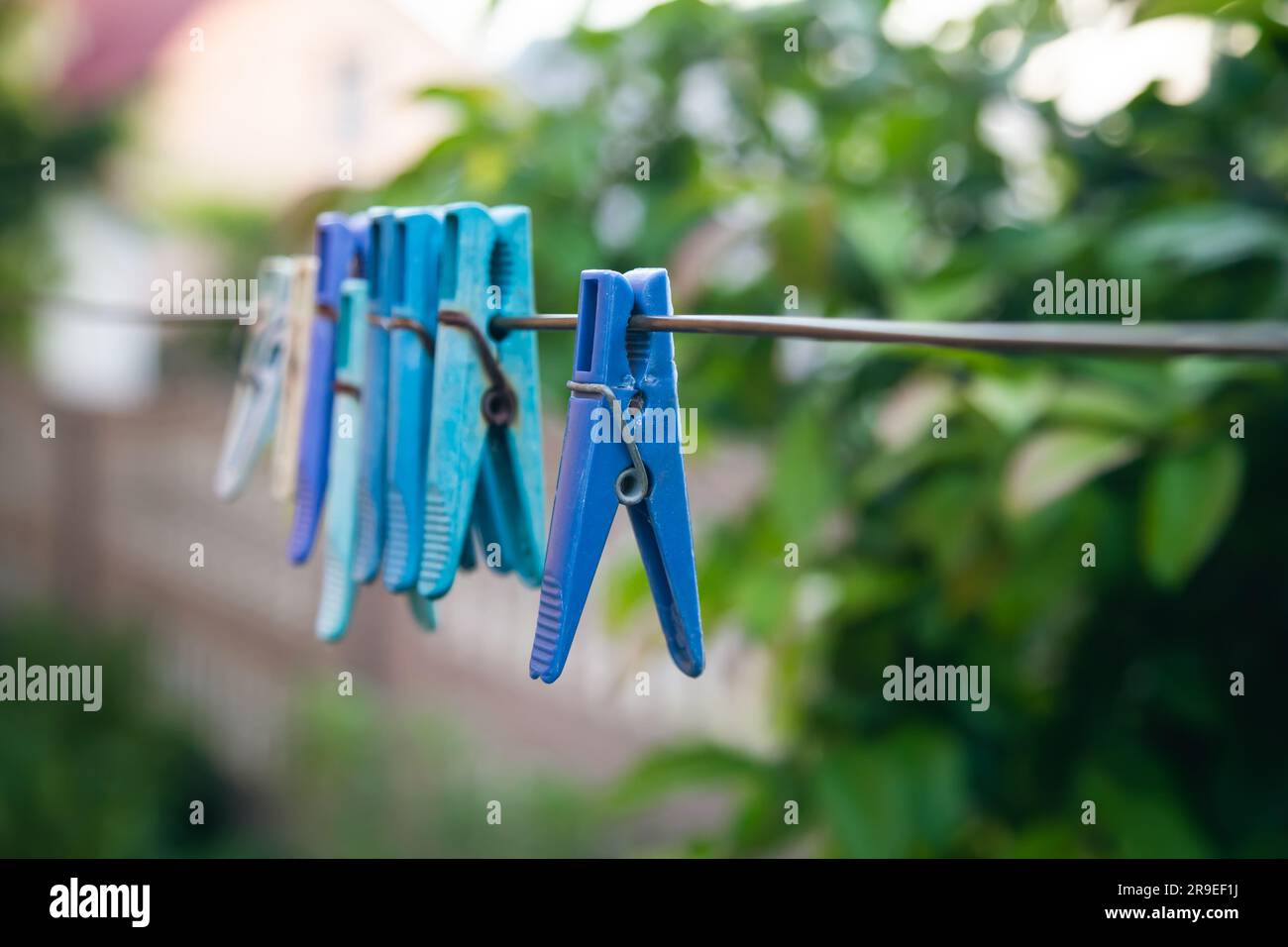 Multi-colored clothespins on a clothesline close up. Stock Photo