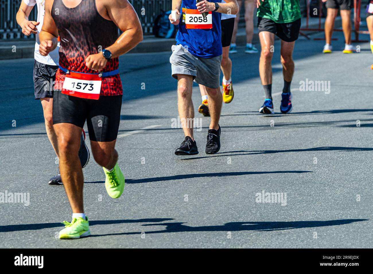 side view group male runners run together in line marathon race