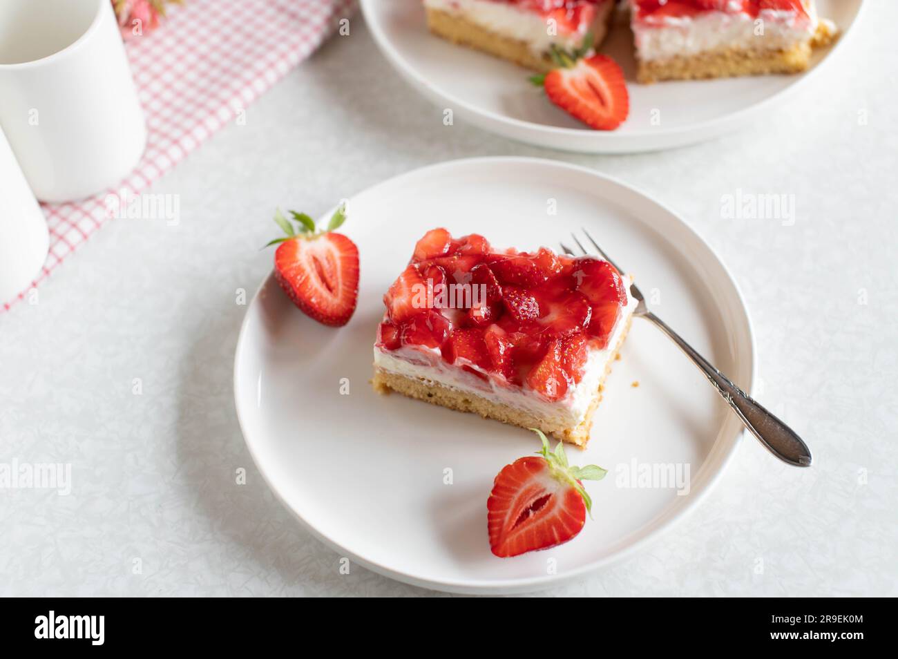 Cake with strawberries, whipped cream and mascarpone cheese on plate Stock Photo