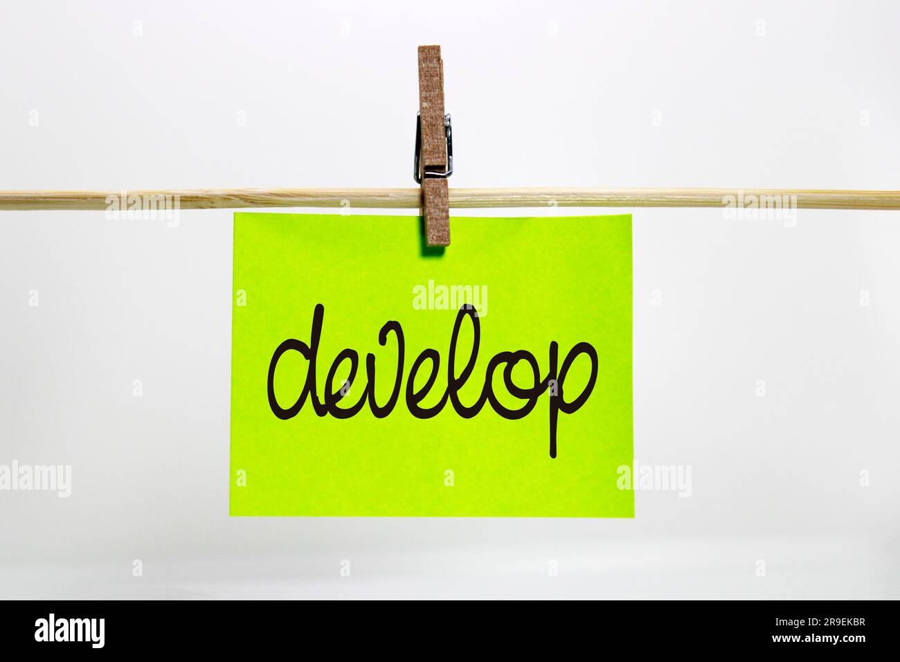 Develop word written on posit attached with clothespins Stock Photo