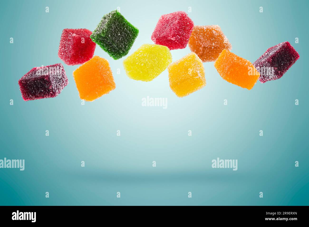 assorted jelly candies floating on blue background. Stock Photo