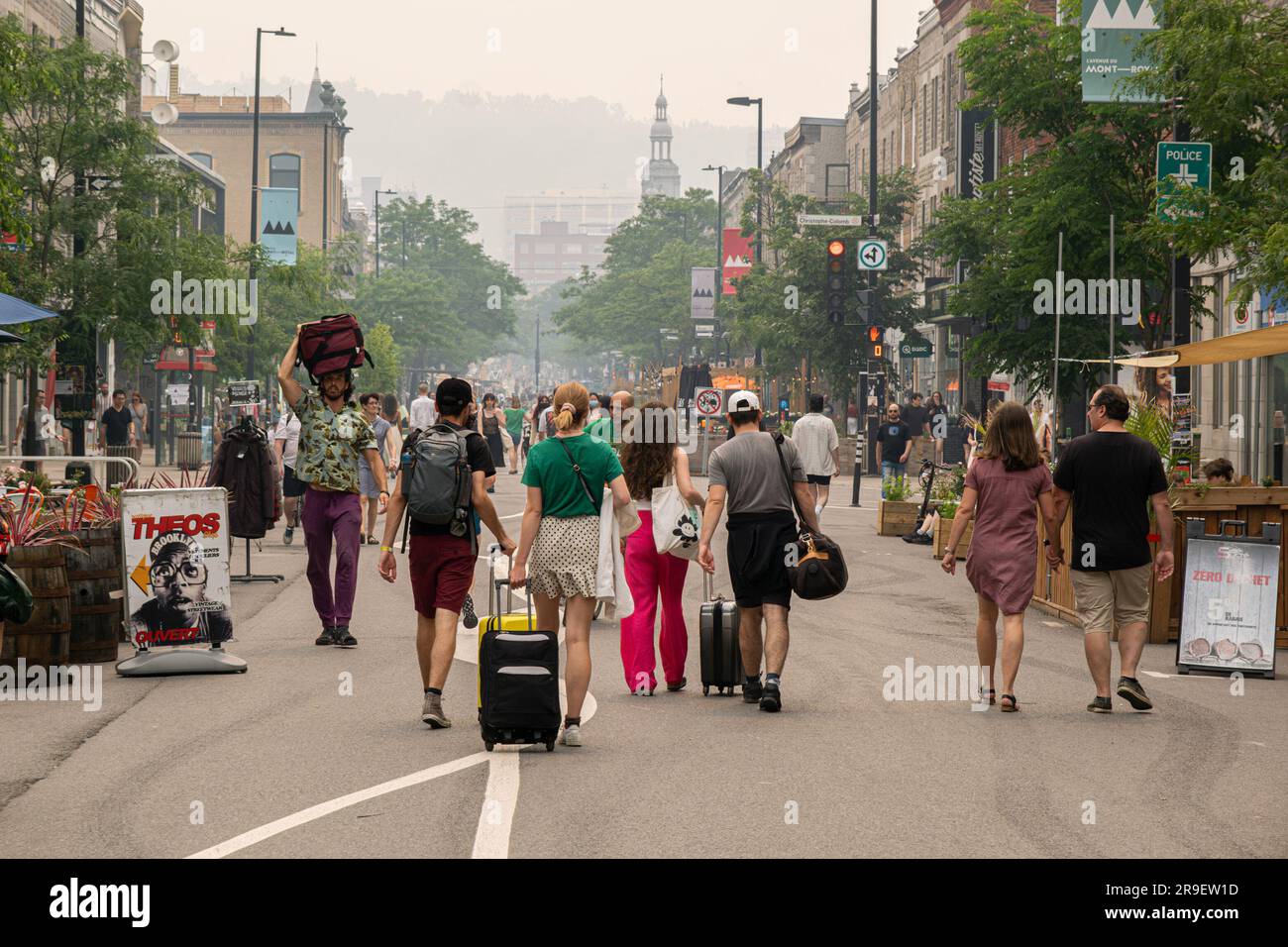 Montreal, CA - 24 June 2023: People walking on Mont-Royal avenue as the city is in the smoke of Canadian forest fires Stock Photo