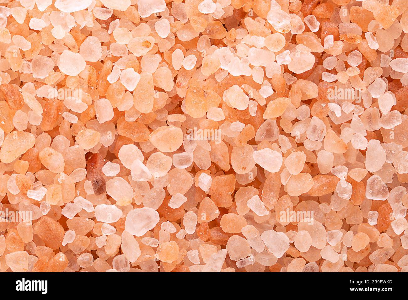 Himalayan salt, coarse crystals, macro photo. Rock salt, halite, with a pinkish tint, due to trace minerals, mined from the Punjab region. Stock Photo