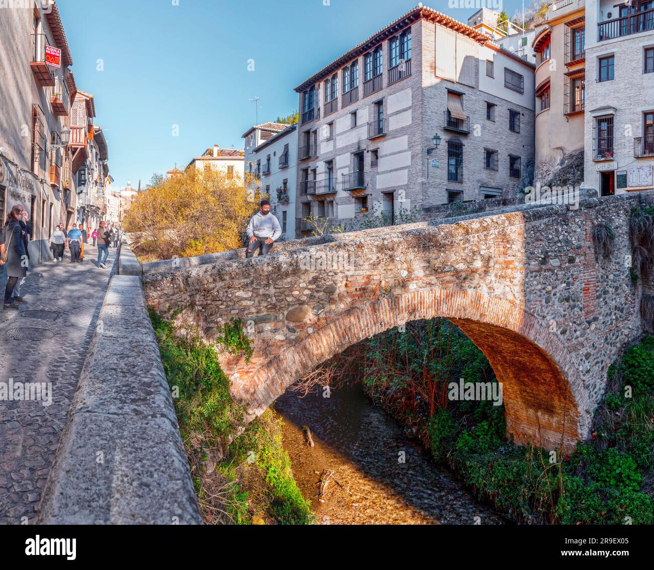 Granada, Spain-Feb 26, 2022: The stone bridge and traditional moorish Spanish architecture around Darro River, Granada, Spain. Stock Photo