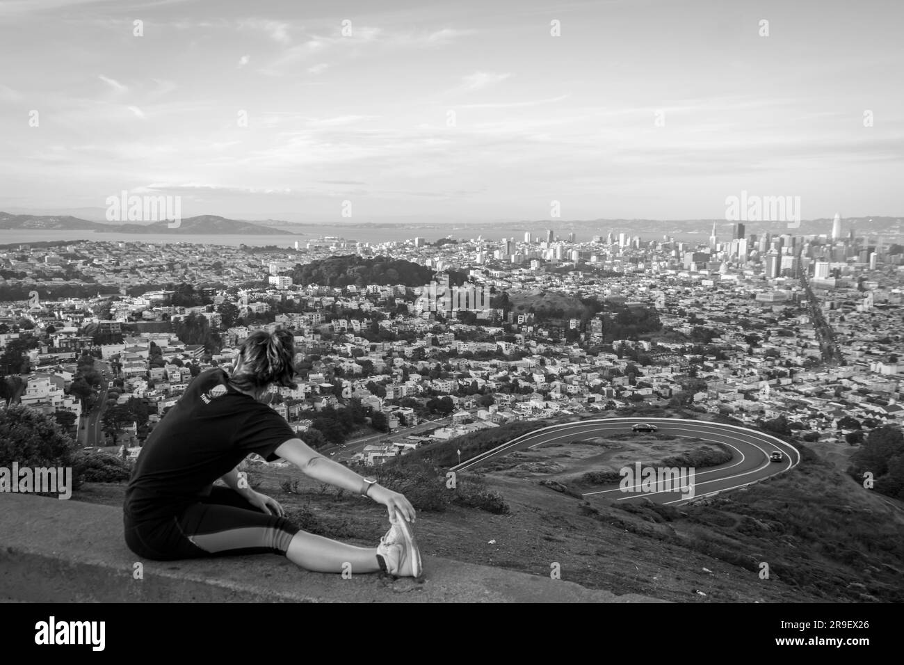 Woman stretching on top of the Twin Peaks Hill in San Francisco, California Stock Photo