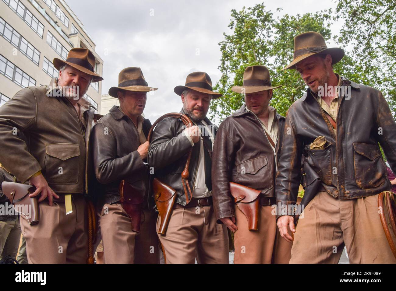 London, UK. 26th June 2023. Indiana Jones fans dressed as their hero pose for a photo ahead of the premiere of Indiana Jones and the Dial of Destiny in Leicester Square. Stock Photo