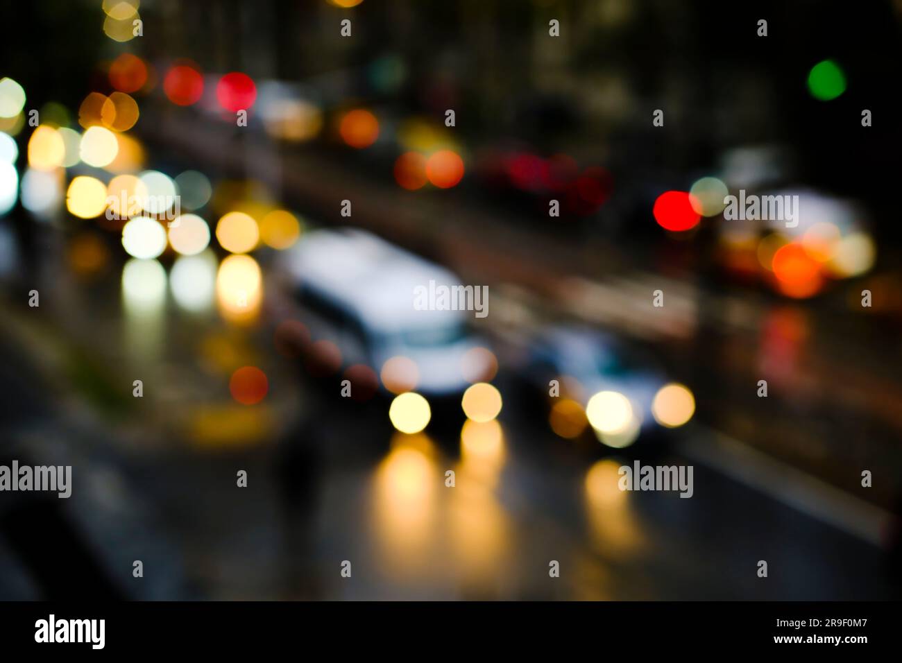 Blurry vehicles and bokeh lights on a road at night time in Istanbul
