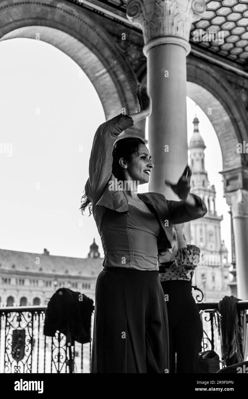Seville, Spain - Feb 24, 2022: Street artist performing flameco art with dancing and live music at the Plaza de Espana in Seville, Andalusia, Spain. Stock Photo